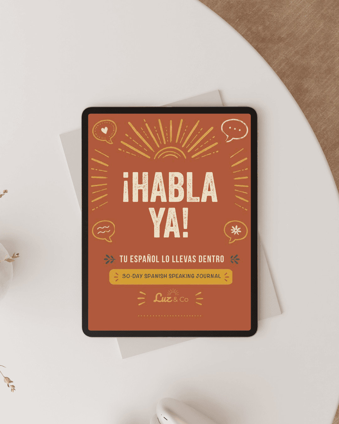 The ¡Habla Ya! 30-day Spanish speaking journal cover shown on a tablet